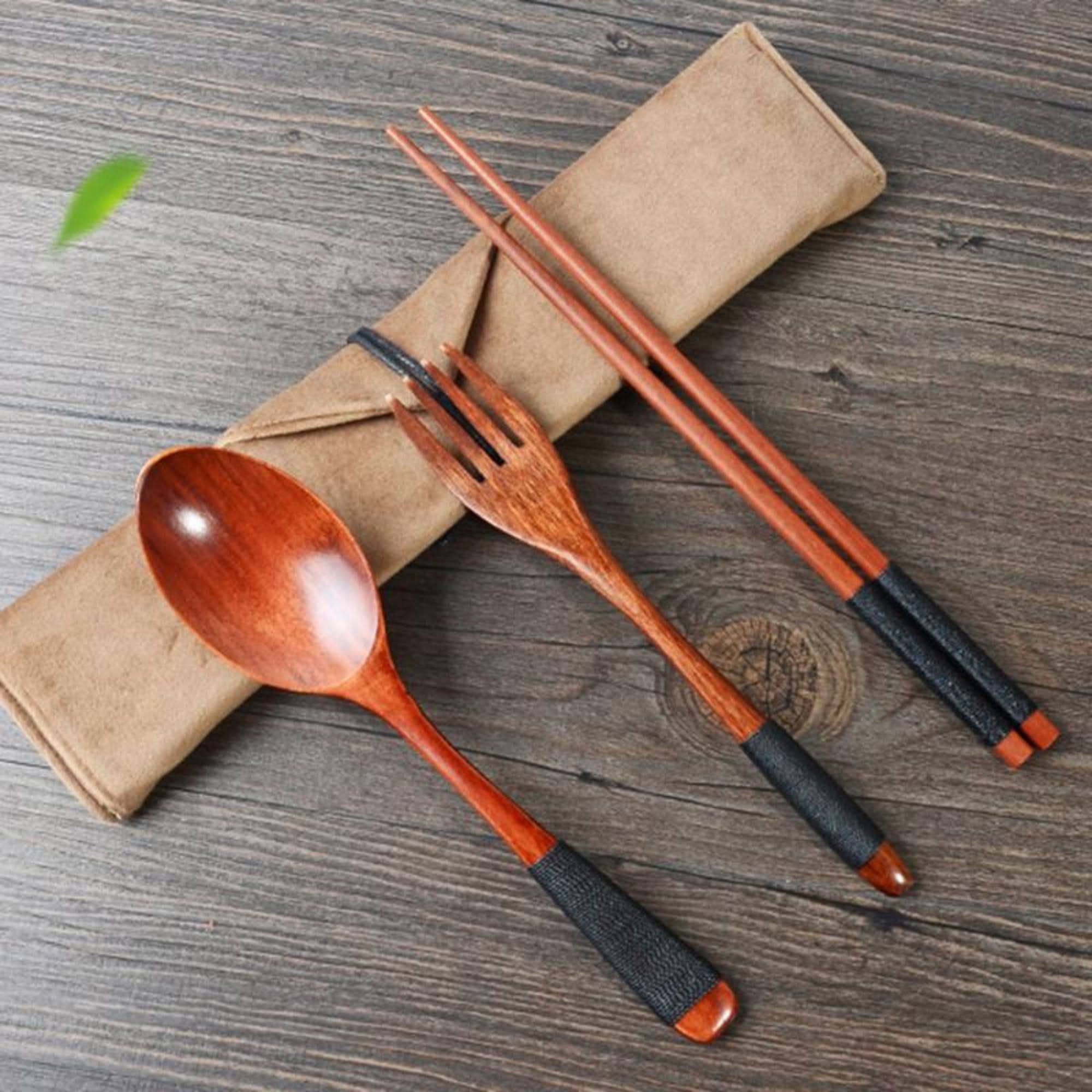 Natural wood Japanese cooking utensil set with case, featuring spoon, fork, and chopsticks.